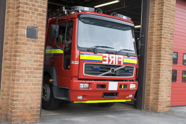 A fire engine leaving the fire station
