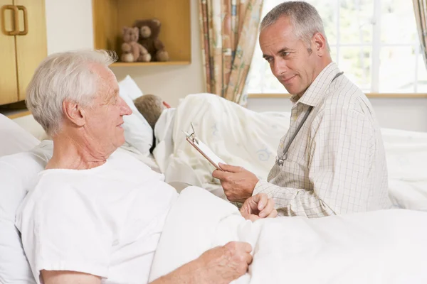 Doctor Checking Up On Senior Man In Hospital — Stock Photo #4779448