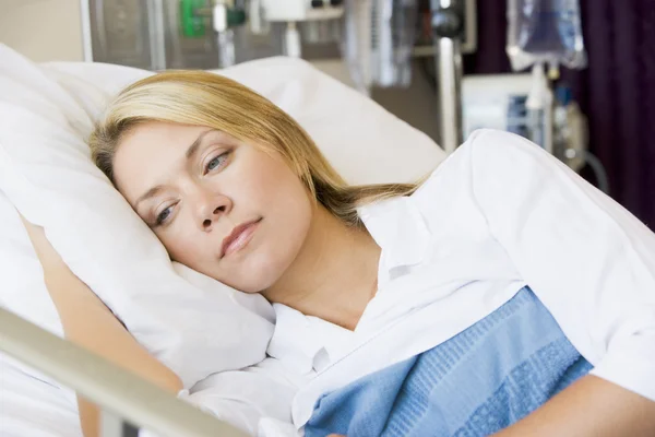 Woman Lying Down In Hospital Bed