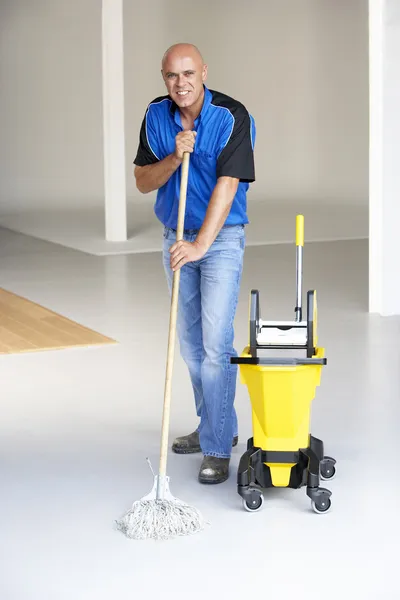 Cleaner mopping office floor — Stock Photo #4815232