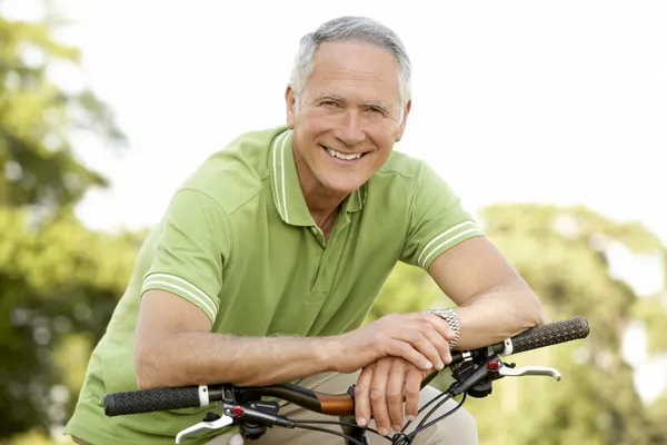 Portrait of man riding cycle in countryside
