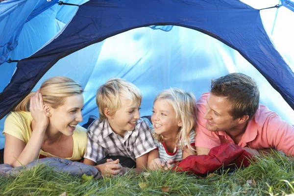 Young family poses in tent