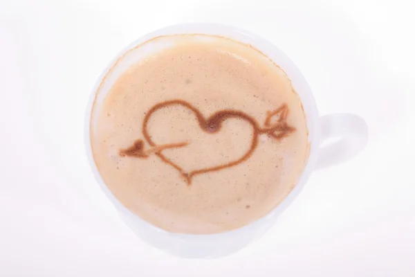 Cup of coffee with the drawn heart on a skin