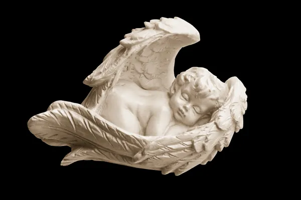 Figurine of the white angel it is sweet sleeping in wings