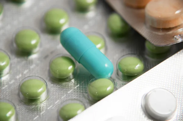 Green pills with syringe