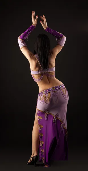 Woman dance in traditional arabian costume - back