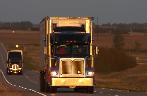Semi trucks and sun glare along Trans Canada Highway