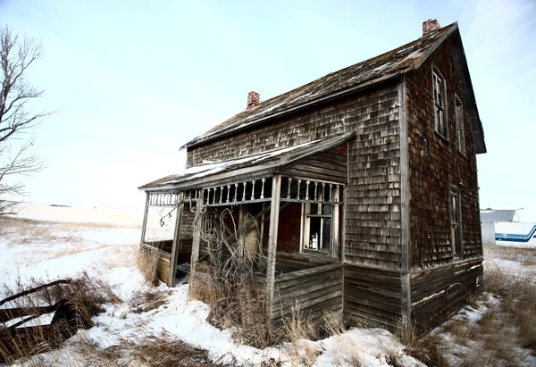 Abandoned old farm house in winter