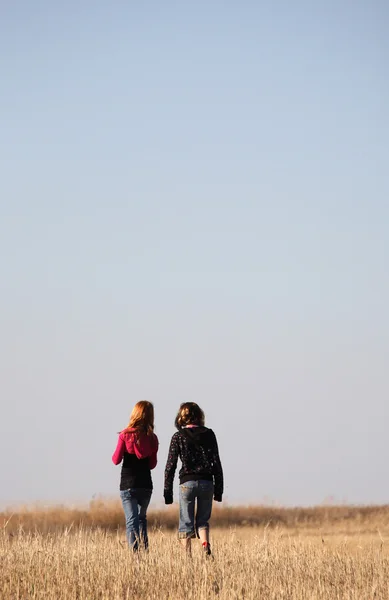 Two girls walking along causeway in scenic Saskatchewan
