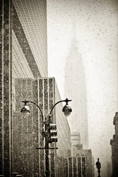 Old-fashioned stylization of silhouette of Empire State building in blizzar