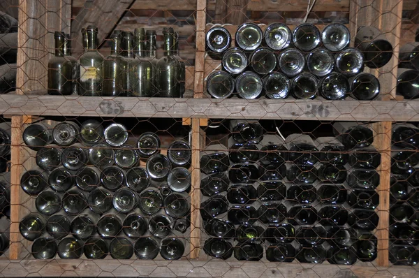 Old bottles in storage shelves