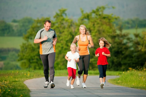 Family jogging outdoors with