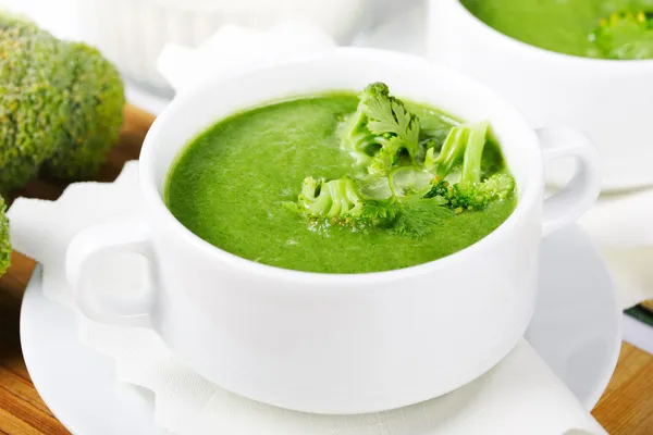 Broccoli fresh green soup in white bowl served for dinner