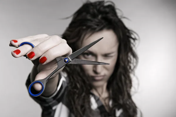 Attractive hairdresser with scissors