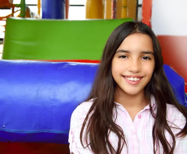 Latin indian teen girl smiling in playground schoolgirl by TONO BALAGUER SL