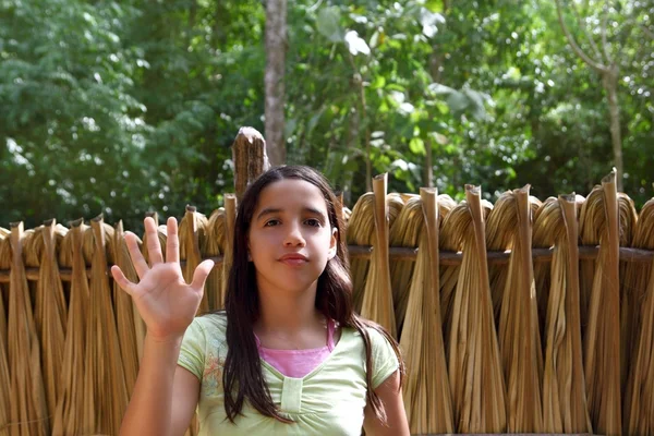 Indian girl waving greeting in jungle south american
