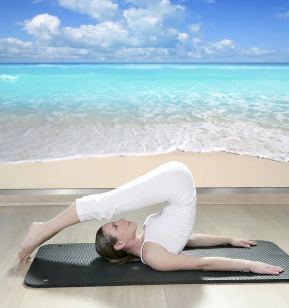 Black mat yoga woman window view of tropical beach