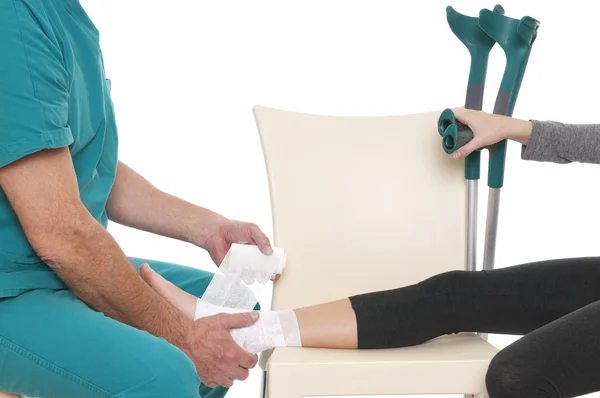 Doctor bandaging ankle