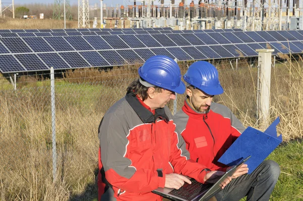Engineers in a solar panel station
