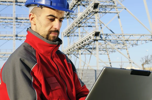 Engineers with laptop in an industrial site