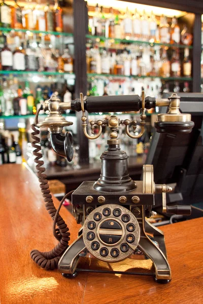 Retro bronze phone on bar table