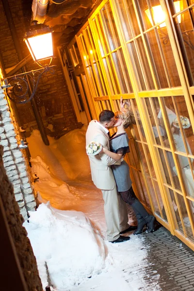 Just married couple outdoors in winter kissing