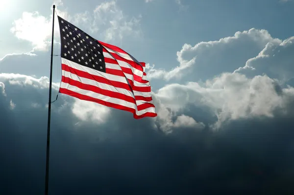 American Flag Against Stormy Skies