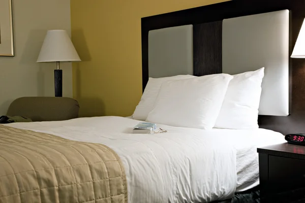 Comfortable bed in typical hotel room