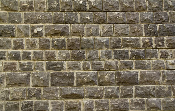 Zwart basalt stenen muur achtergrond — Stockfoto