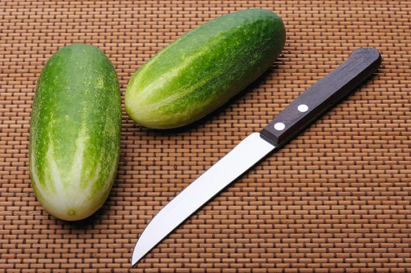 Cucumbers and knife — Stock Photo, Image
