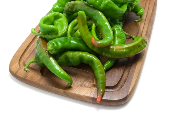 Hot peppers on kitchen board — Stock Photo, Image