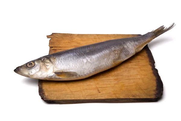 Herring on old wooden board — Stock Photo, Image
