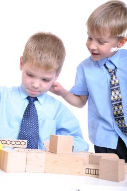 Boys playing with bricks clipart