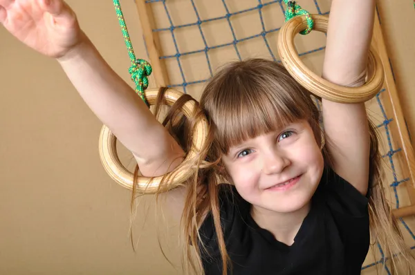 Child playing at gymnastic rings — Stock Photo, Image