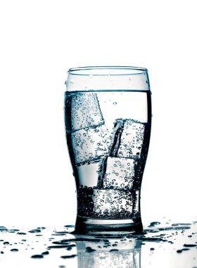 Glass with cold purified water and ice clipart