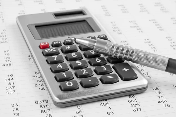 Calculator and pen on a business background — Stock Photo, Image