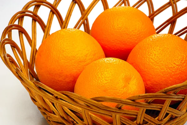 Korb mit Orangen auf weißem Hintergrund — Stockfoto