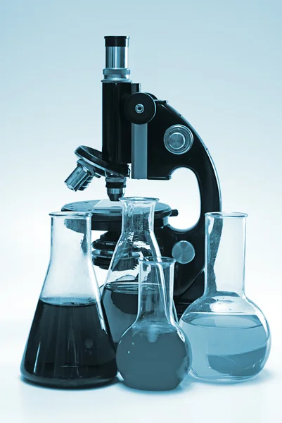 Chemische Laborgläser und Mikroskop Stockbild