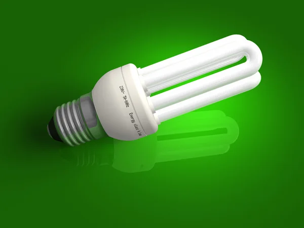 Lampada a basso consumo energetico su verde — Foto Stock