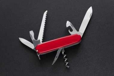 Swiss army knife isolated on black clipart