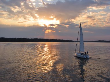 Evening sail by the lake clipart