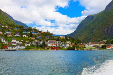 Mountain village in fjords, Norway clipart
