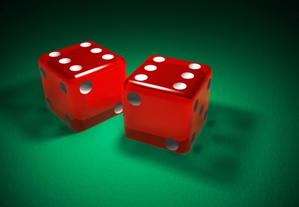 Red transparent dice on green surface — Stock Photo, Image