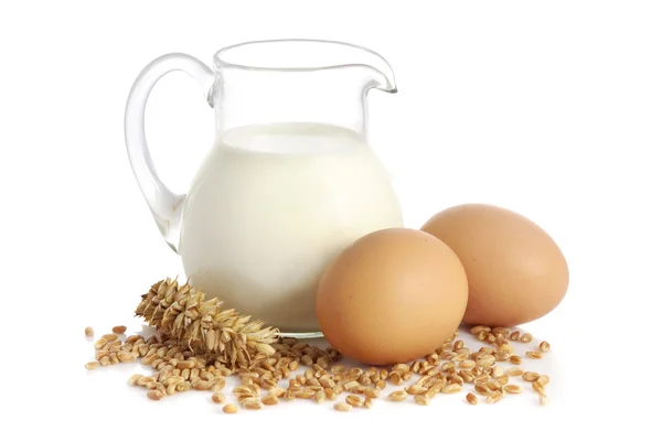 Fresh milk, wheat seeds and two eggs — Stock Photo, Image