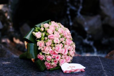 Wedding bouquet of pink roses with rings