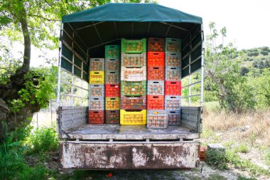 Truck with orange boxes in village. clipart