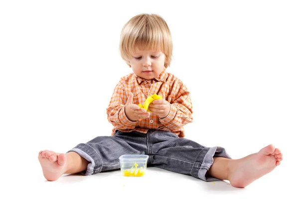 Stock image Cute little boy molding plasticine