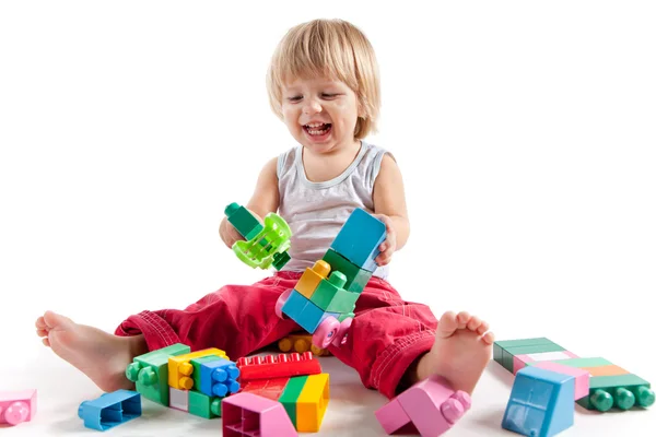 Rindo menino brincando com blocos coloridos — Fotografia de Stock