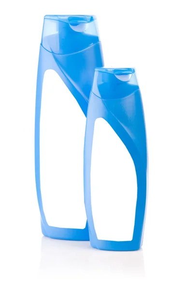 Geïsoleerde blauwe shampoo flessen — Stockfoto