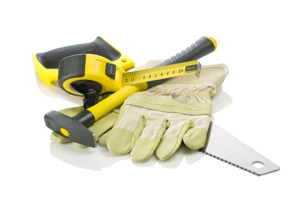 Gloves, tapeline, saw and hammer — Stock Photo, Image